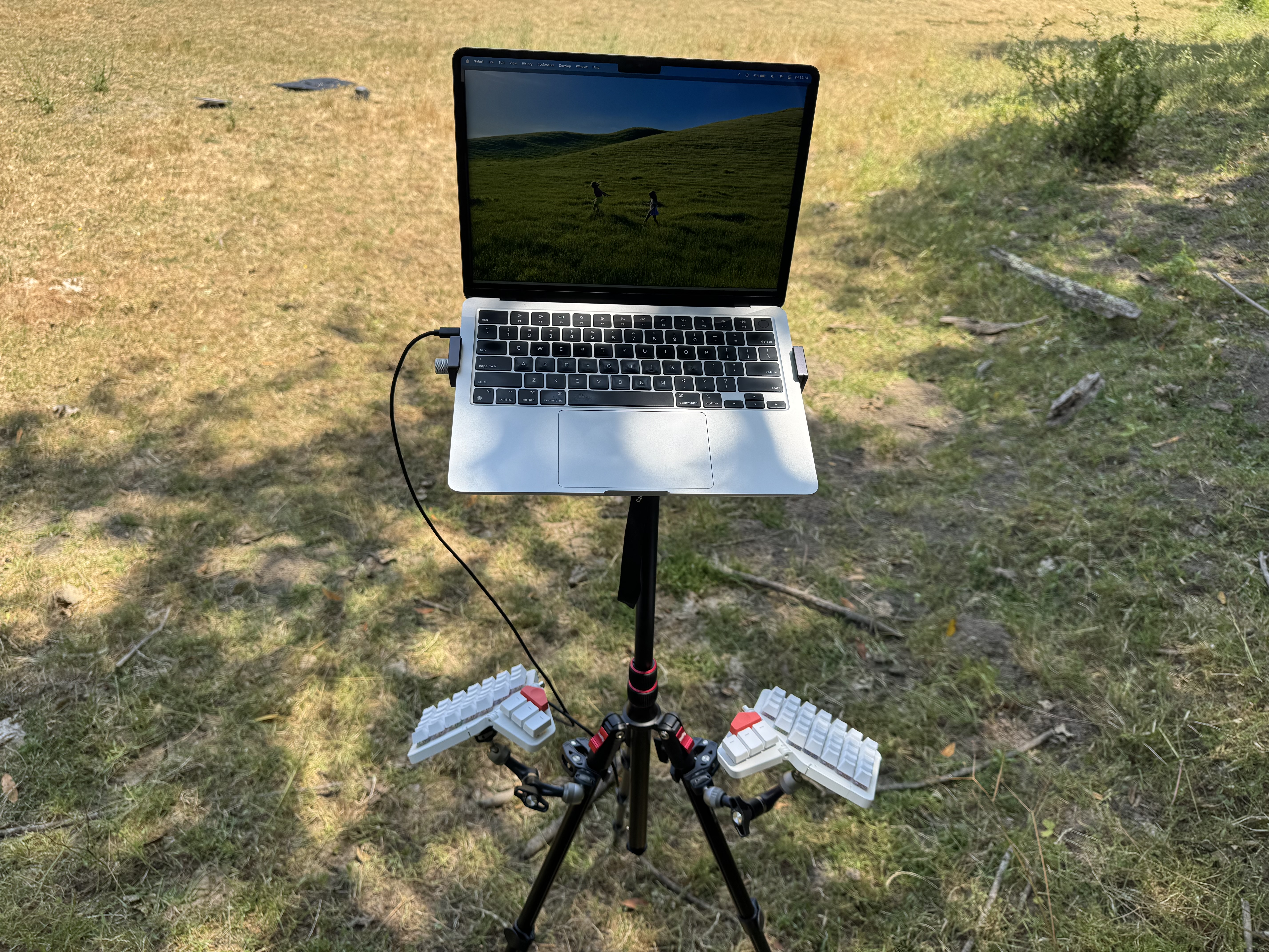 Moonlander keyboard and MacBook Air mounted to a tripod